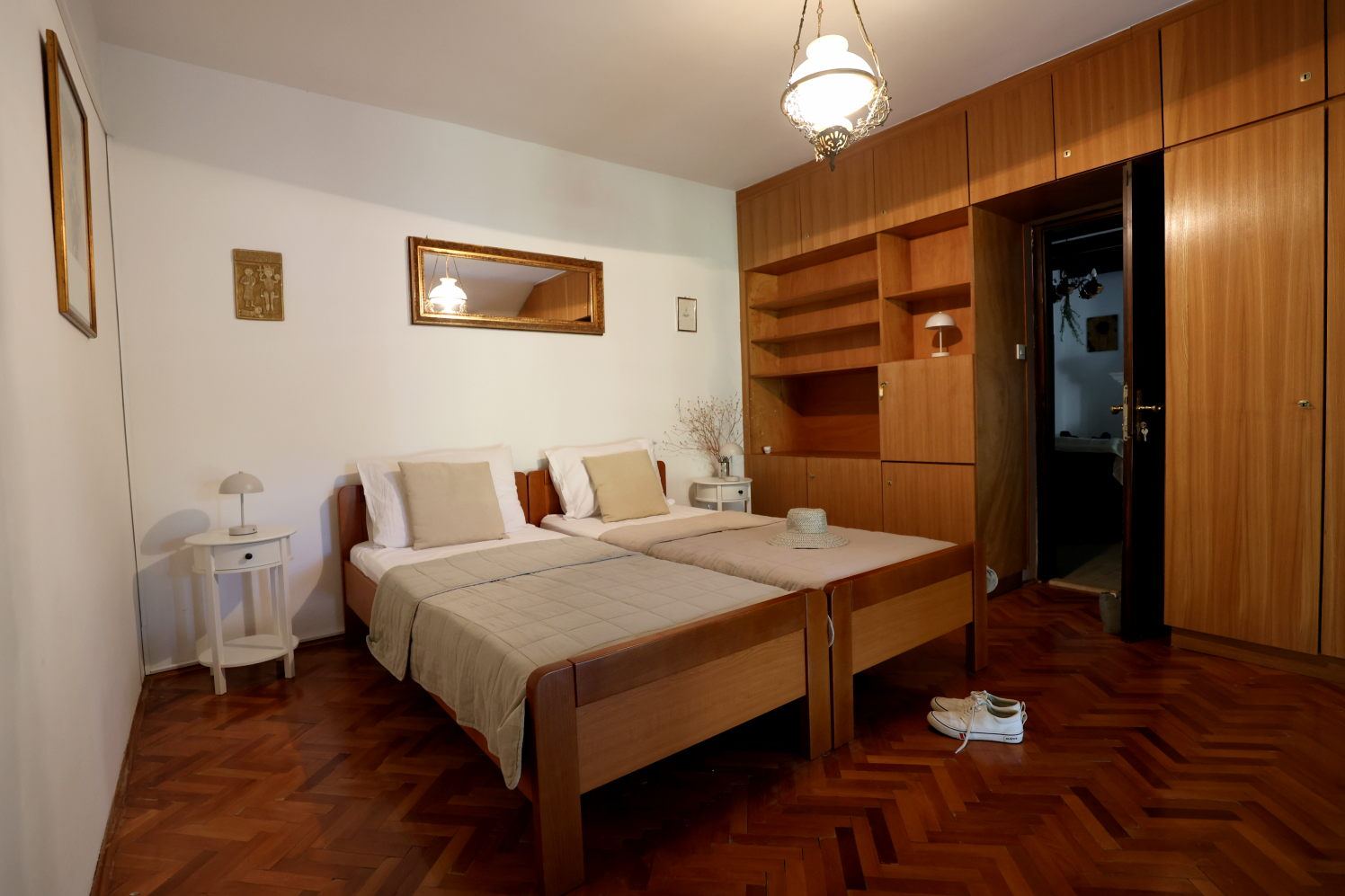Second bedroom with two single beds and wooden wardrobes