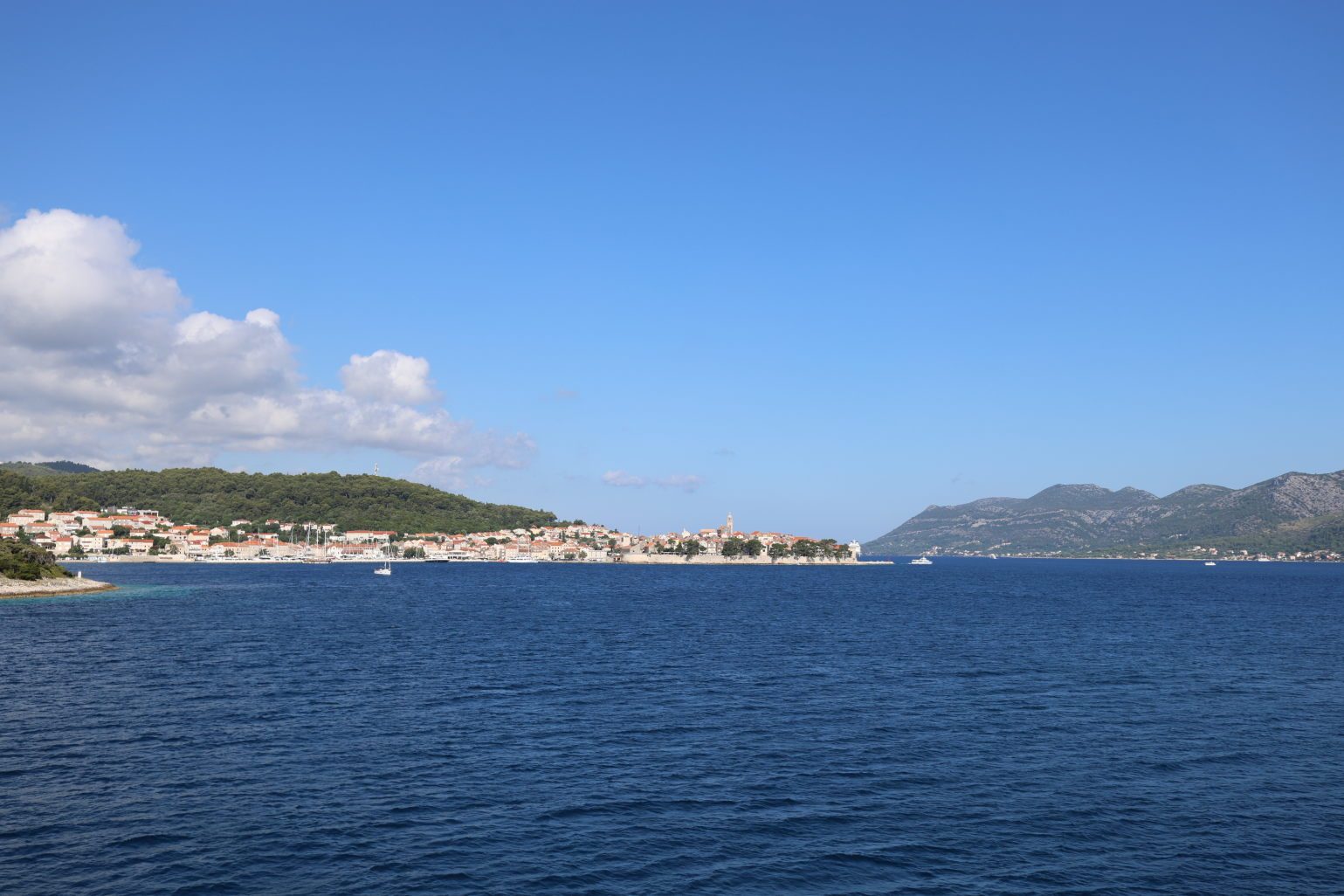 Korčula town across the open sea, the mountains of Pelješac behind