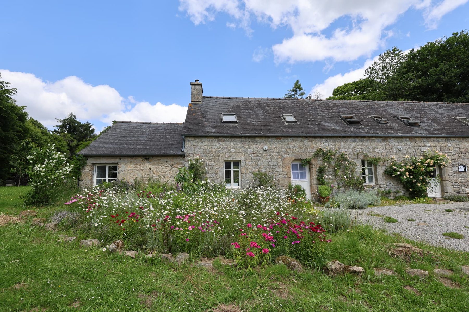 The Breton longère seen across the garden
