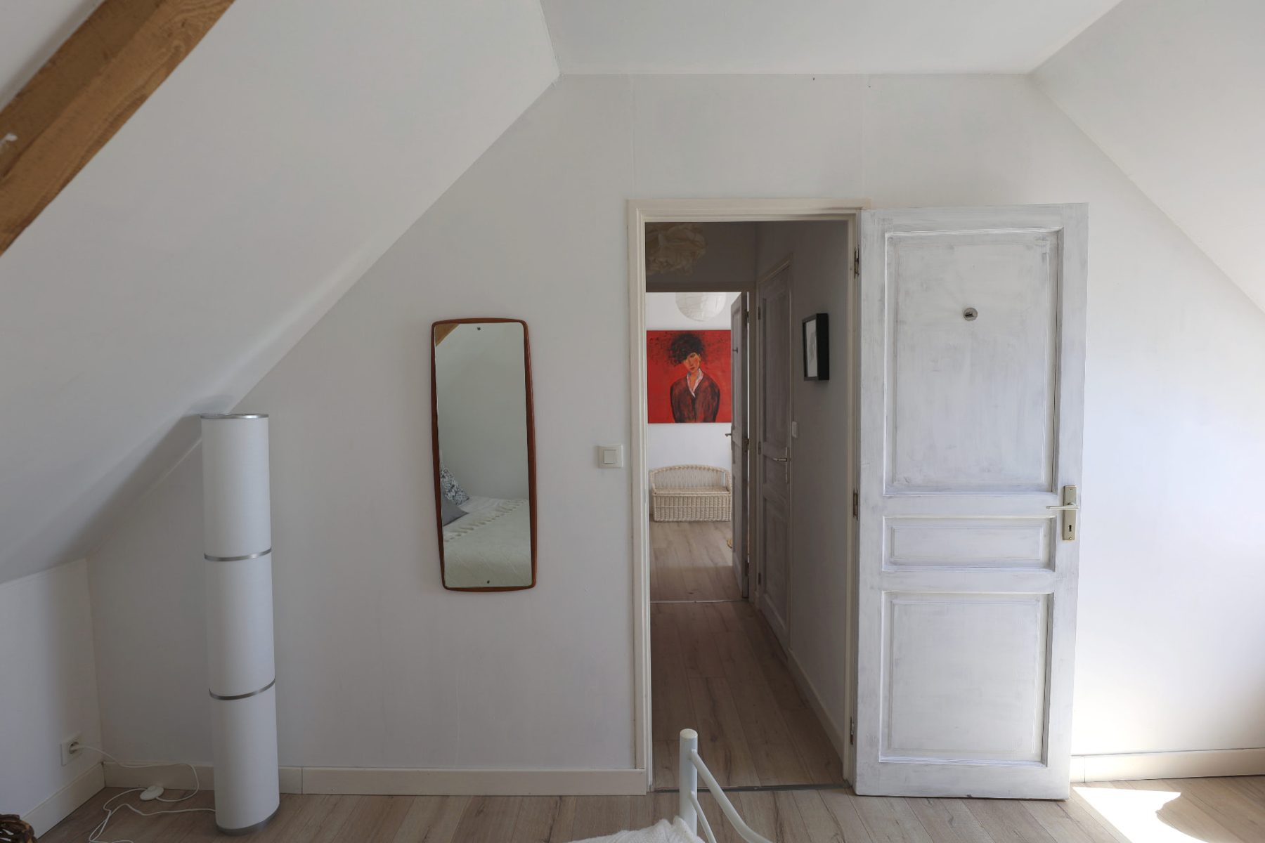 Upstairs, a doorway looking along the landing to a red painting